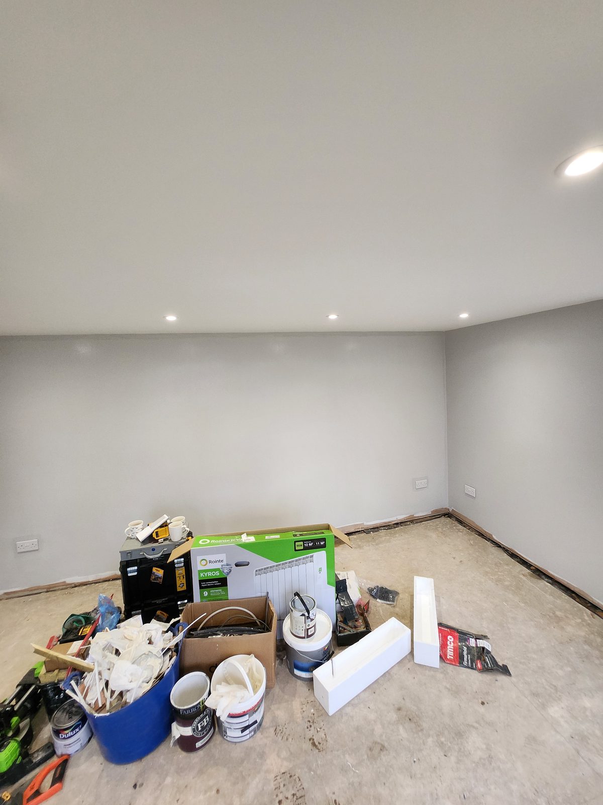 Grey painted room with recessed lighting