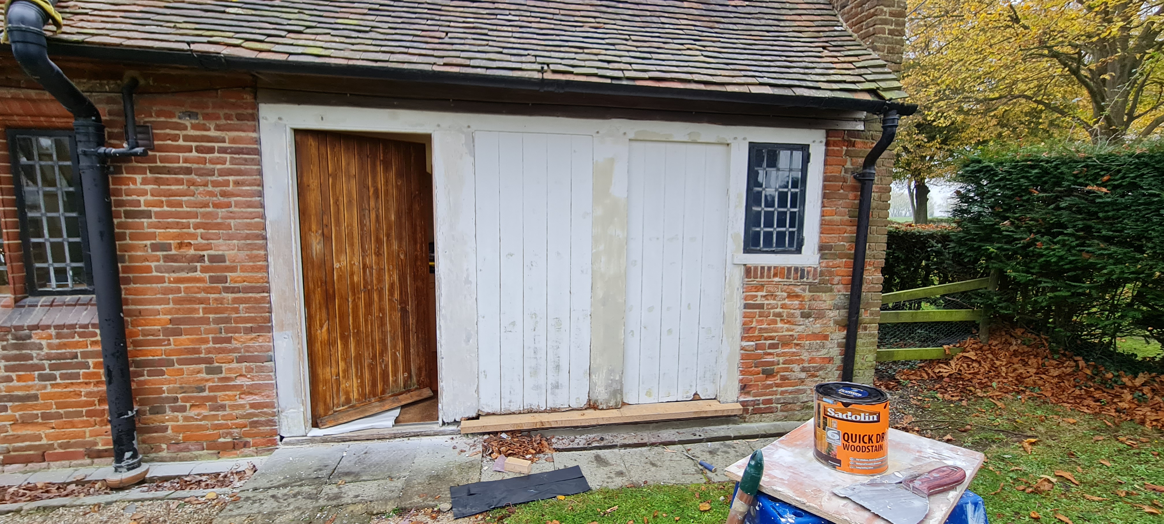 Country outbuilding before exterior painting — weathered woodwork