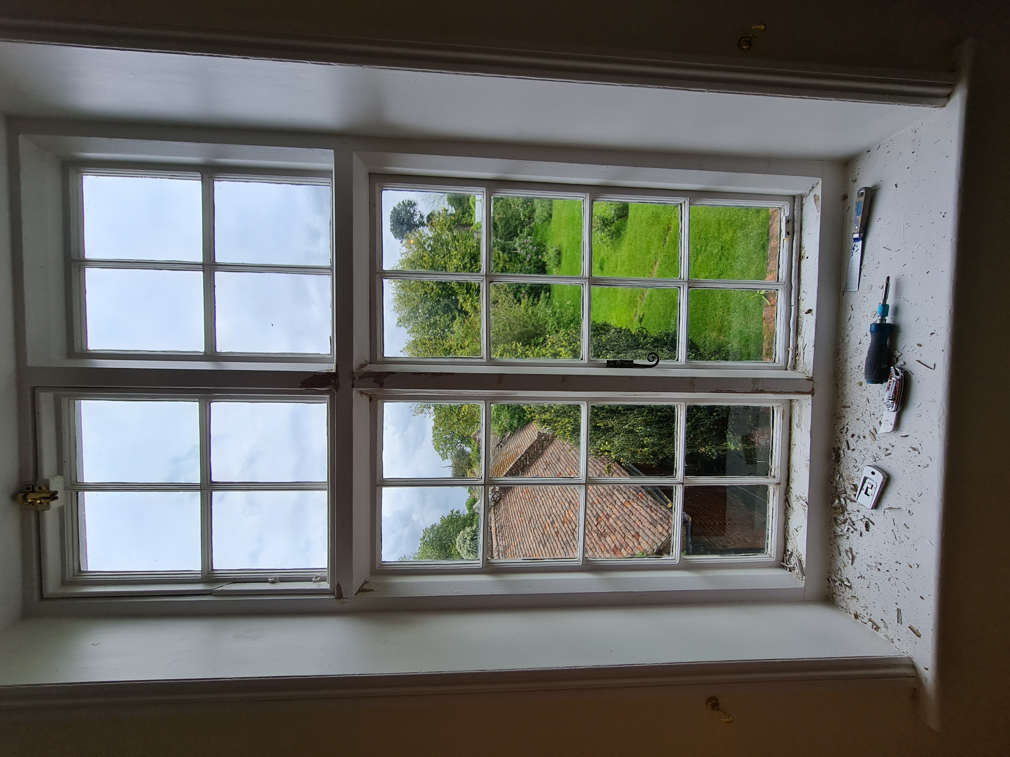 Sash window with surround stripped back during preparation