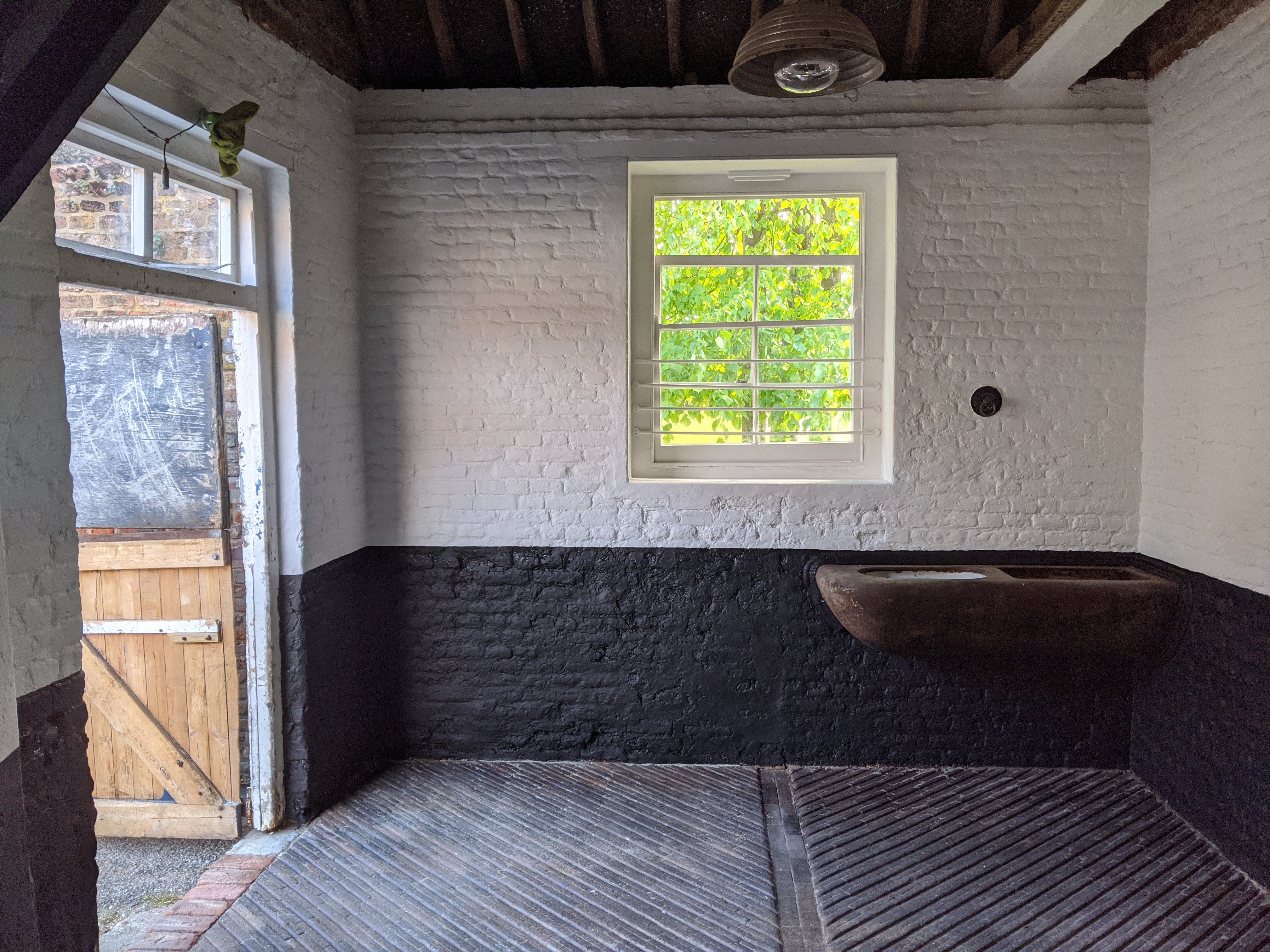 Stables tack room interior painted in black and white