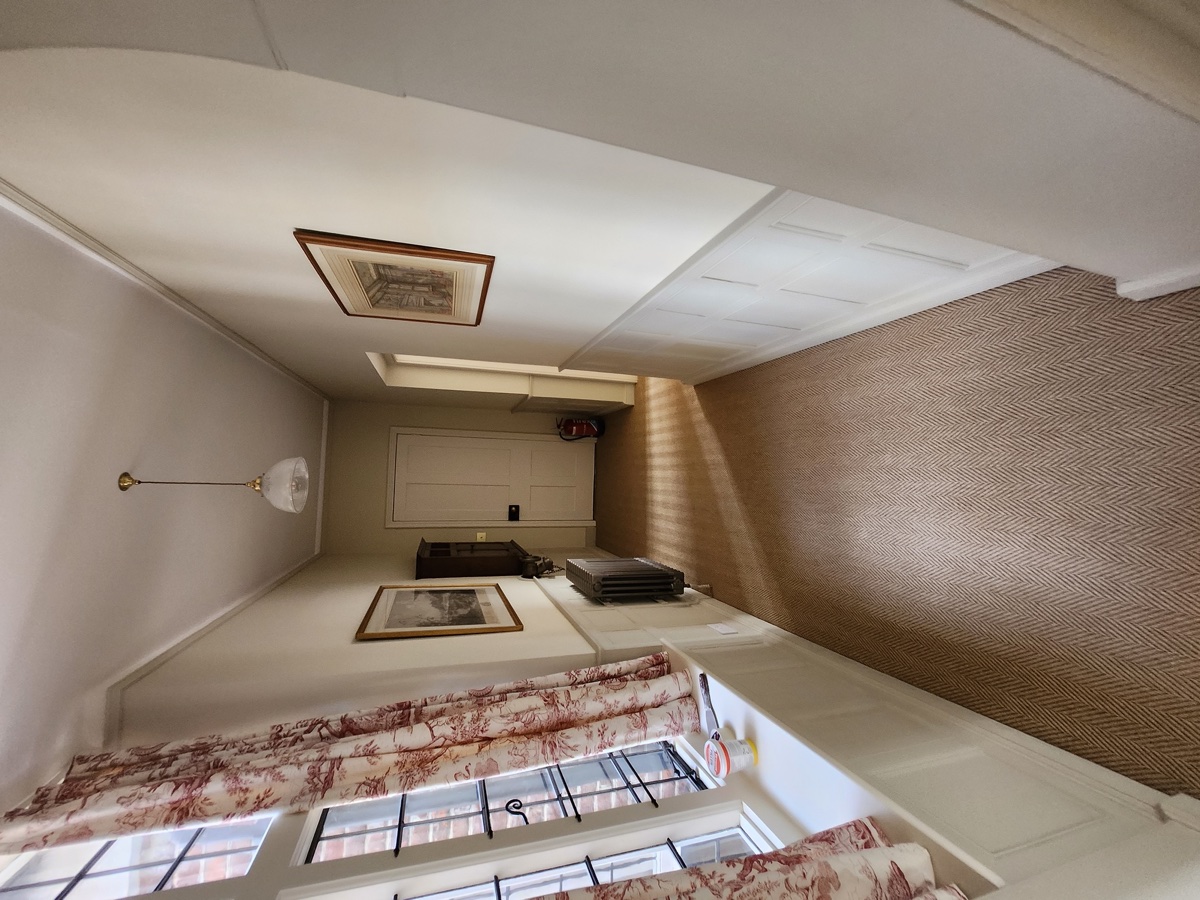 Herringbone pattern wallpaper hung in a reception room
